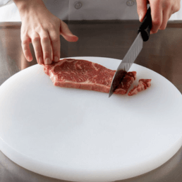 cutting-beef-on-plastic-board